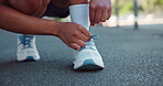 Hands, tying shoes and city athlete for getting ready, running training and outdoor for activity. Woman, fitness preparation and urban street for footwear, marathon and tie laces in town for workout