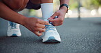 Hand, tying shoes and city athlete for getting ready, running training and outdoor for activity. Female person, fitness preparation and urban street for footwear, strong legs and tie laces in town