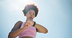 Outdoor, tired and black woman with smart watch, training and challenge with fatigue, blue sky and exercise. Person, breathing or runner with progress, check time or monitor heart rate with space