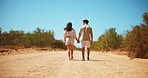 Holding hands, outdoor and couple with love, back and romance with relationship. Nature, vacation and happy man with woman, care and marriage with summer holiday, countryside and bonding together