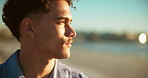 Man, relax and sunset at ocean with thinking, calm and fresh air with travel. Person, daydreaming and face at beach with peace, vacation break and reflection for mindfulness with space at seaside