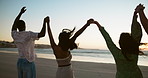 Holding hands, beach and people with sunset, friends and celebration with summer holiday. Seaside, nature and group with weekend break, ocean and cheering with reunion, trust and support in Zanzibar
