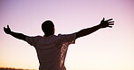 Back, man and sunrise with freedom outdoor for summer vacation, travel and celebration. Male person, arms spread and holiday adventure, calm morning and weekend break with getaway achievement of trip