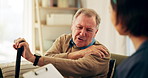 Senior man, nurse and shoulder pain with cane, support and healthcare for retirement. Patient, caregiver and person with a disability for nursing home, rehabilitation and medical elderly care