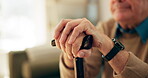 Cane, hands and old man with disability in home, healthcare and rehabilitation from stroke. Nursing house, senior person and closeup with walking stick for balance support, recovery and osteoporosis