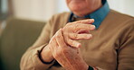 Nursing home, hand and senior person with arthritis or numbness of fingers in lounge, pain or sick. Retirement, closeup and pensioner with carpal tunnel syndrome, injury or rehabilitation for disease
