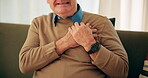 Home, old man and hands on chest for pain, viral infection and heart attack signs in living room. Retirement, senior person and discomfort with respiratory illness, cardiac symptoms and tuberculosis