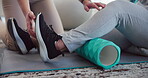 Physiotherapy, foam roller and legs of person in clinic for consulting, help and fitness. Joint pain, physical therapy and healing with closeup of people in office for workout, health or muscle relax