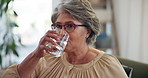 Senior woman, drinking water and pills on sofa in home with morning routine, schedule and health in retirement. Elderly person, glass and liquid for medicine, supplement and benefits for wellness