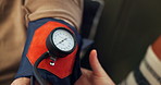 Blood pressure, monitor and reading with wrist of person closeup for healthcare or medical appointment. Hands, hypertension and monitor with patient in hospital for checkup, evaluation or screening