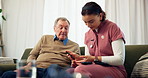 Diabetes pen, nurse and old man on sofa, nervous and consultation in living room. Mature patient, home and medical with professional, healthcare and needle prick with insulin, injection and wellness