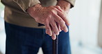 Hands, walking stick and retirement in home with balance, steps and recovery from injury in morning. Elderly person with disability, wooden cane and rehabilitation process for mobility at apartment