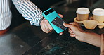 Card, machine and hands of customer in coffee shop for fintech payment, sale or checkout. POS, finance and barista with person for contactless transaction by counter in cafeteria or restaurant.