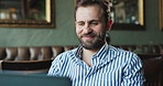 Man, laptop and smile in cafe for remote work, new opportunity and typing email for advice. Writer, happy and computer in restaurant for business article, forum discussion and positive feedback