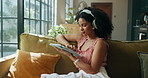 Headphones, music and woman with tablet in home for streaming sound, subscription or scroll media. Living room, audio technology and African person listening to song, radio and audiobook on internet