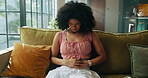 Pain, sick and woman with stomachache, home and menstrual cramps in living room, massage or health. Lounge, uncomfortable and person with pelvic inflammatory disease, abdominal and infection in house