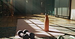Exercise, water and dumbbell for fitness by mat, home and hydration fr wellness after training session. Workout equipment, floor and h2o bottle for beverage, headphones and thirst in modern apartment