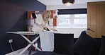 Woman ironing shirt in living room for work, business event or job interview in apartment. Laundry, businesswoman getting ready at ironing board in home and balance between housekeeping and career.