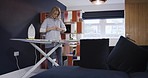 Woman, nurse iron clothes or uniform, dressing for work in morning in her home while getting ready. Mature lady cleaning, doing chores with ironing board and shirt or laundry for routine service