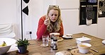 Woman, thinking and eating soup with spoon while hungry for healthy, warm comfort food on vegan diet at lunch. Health, nutrition and dinner time for female with healthy lifestyle in russia home
