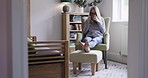 Relax, coffee and woman on sofa in the living room of her modern home alone. Calm, rest and mature lady sitting on couch or chair while drinking tea for relaxing morning