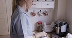 Nurse, coffee and morning in house of woman making tea for energy, relax and before leaving home kitchen for work. Female healthcare, medical and nursing worker with cup for motivation to start day