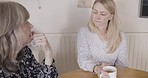 Coffee, mother and daughter in communication, talking and speaking about advice, problem or stress in a home. Senior parent, tea and support from family, listening to conversation and relax in house