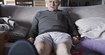 Relax, rest and senior man on a sofa in the living room of his retirement home in Australia. Calm, retired and elderly guy laying and relaxing in pajamas on a couch in the lounge of nursing facility.
