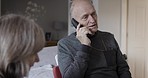 Call, physiotherapy and rehabilitation with a senior man talking on his phone while in his retirement home with his wife. Healthcare, conversation and mobile with an elderly male in recovery