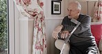 Alzheimer, dementia and senior man in nursing home on sofa, looking out window and in reflection. Rehabilitation, retirement and lonely elderly male with sadness, depression and mental health issue