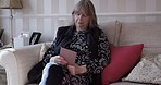 Retirement, video call and mature woman with tablet for online communication while relaxing at home. Video conference, digital tablet and senior female with wifi conversation with contact 