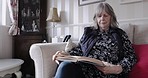 Relax, peace and senior woman reading a book on the living room sofa of her house. Retirement, calm and elderly lady with a story for knowledge from books while on the couch in the lounge at a home