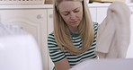 Woman, laundry and washing machine for cleaning, clothes and hygiene in home for chores with focus. Cleaner, housekeeper and fabric with tumble dryer, electrical appliances and tech for clean house