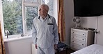 Senior man, stretching and morning in bedroom for wellness, health or exercise of muscles in home. Elderly, retirement and ready with fitness, healthy start or warm up in pajamas in house for cardio
