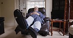 Senior man, foot exercise and rehabilitation while on a couch in home living room to relax, rest and physical therapy in retirement. Elderly person with arthritis, fibromyalgia or orthopedic problem