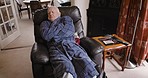 Old man, tired and sleeping on a chair in the living room of his retirement home for a peaceful rest. Retirement, elderly male and sleep or nap with fatigue while relaxing and dreaming 