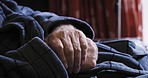 Hands shaking, disability and senior man with Parkinsons on sofa in nursing home. Healthcare, chronic disease and disabled old man with mobility problem, compassion for senior care and rehabilitation