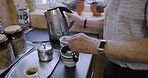 Man hands, kitchen kettle and water for tea in mug, cup and morning breakfast, drinking and home. Closeup old man, boiling water and tea bag, electrical appliance and heating liquid for hot beverage