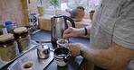 Hands, tea and kitchen with a senior man preparing a drink alone in his retirement home from above. Morning, mug and kettle with a mature male pensioner making a beverage in his house closeup