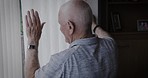 Senior man, hand wave and window while greeting neighbor and closing blinds at night for privacy in living room at home. Elderly person waving at person for kindness and to be social in UK house