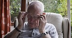 Senior man, vision and eye care glasses in house or nursing home for reading, life insurance prescription or glaucoma treatment. Relax, couch and retirement elderly with eyewear for myopia optometry