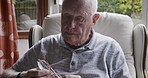 Glasses, relax and reading with old man on sofa for vision, learning and peace at home. Development, learning and books with senior citizen in living room for literature, comfortable and retirement  