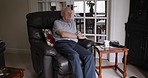 Retired, senior man and thinking on a chair in his home while relaxing and feeling thoughtful or contemplative. Contemplation, thought and think with an elderly man daydreaming about memories 
