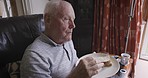 Senior man, home sofa and eating sandwich or bread while hungry at breakfast or lunch and sitting alone in the living room. Old person on couch with a meal for nutrition and a healthy lifestyle