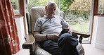 Senior man, phone and typing on sofa in home, texting message or social media. Retirement, relax and elderly male from Canada on couch in lounge with mobile smartphone networking or internet browsing
