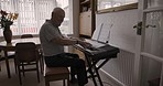 Music, elderly man and piano in a living room, singing and having fun alone in his home. Musician, retirement and senior man playing keyboard alone in a lounge, happy and enjoying retired lifestyle
