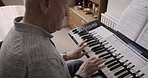 Senior man, keyboard and piano in home, learning musical instrument and practice song. Old man, musician and pianist teacher, reading sheet music and performance, retirement and classical composer 
