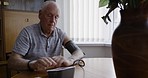 Senior man, blood pressure and health check, machine and monitor body for hypertension, diabetes or self care in home. Elderly male, medical technology and equipment for high blood pressure in house
