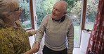 Senior couple, disability and help with walking, balance and support in their home together. Love, trust and elderly woman helping man in a wheelchair, standing and holding hands while bonding