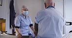 Healthcare, blood pressure and caregiver, old man on bed in nursing home. Retirement, senior care, grandpa and nurse in mask checking health and covid with monitor in bedroom at hospital or clinic.